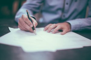 Baltimore Property Manager Signing Rental Registration Papers
